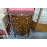 A French Louis XV style walnut and gilt metal mounted serpentine chest of drawers