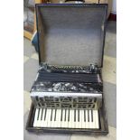 A piano accordian, cased