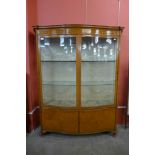 A Victorian Sheraton Revival satinwood serpentine display cabinet, 168cms h, 145cns w, 42cms d