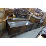 A carved oak tallboy and matching dressing table