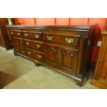 A George III style oak and mahogany crossbanded dresser, 88cms h, 200cms w, 55cms d