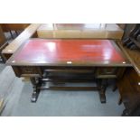 An oak and red leather topped three drawer desk