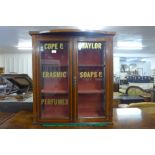 An Edward VII inlaid mahogany two door cabinet, doors bearing Cope & Taylor, Erasmic Soaps &