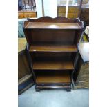 A mahogany open waterfall front bookcase