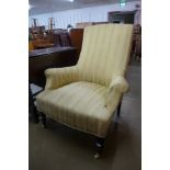 A Victorian ebonised and upholstered armchair