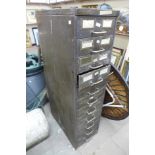 A green metal industrial eleven drawer index cabinet
