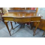 An Edward VII mahogany serpentine single drawer side table, made by Henry Barker Ltd., Nottingham