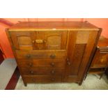 An Arts and Crafts Letchworth oak nursery cupboard, attributed to Ambrose Heal for Heal & Sons