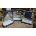 A set of three miniature mirror back display cases