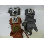 Three cameras in cases, Balda and two Kodak