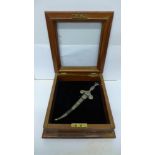 A small dagger in a wooden display box