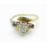 A yellow metal set three stone diamond and sapphire ring, 4.1g, L, tests as 18ct gold, approximately
