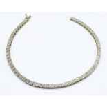 A 9ct gold and diamond line bracelet with approximately sixty small diamonds, 6.5g