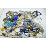 A collection of costume jewellery including brooches and beaded necklaces