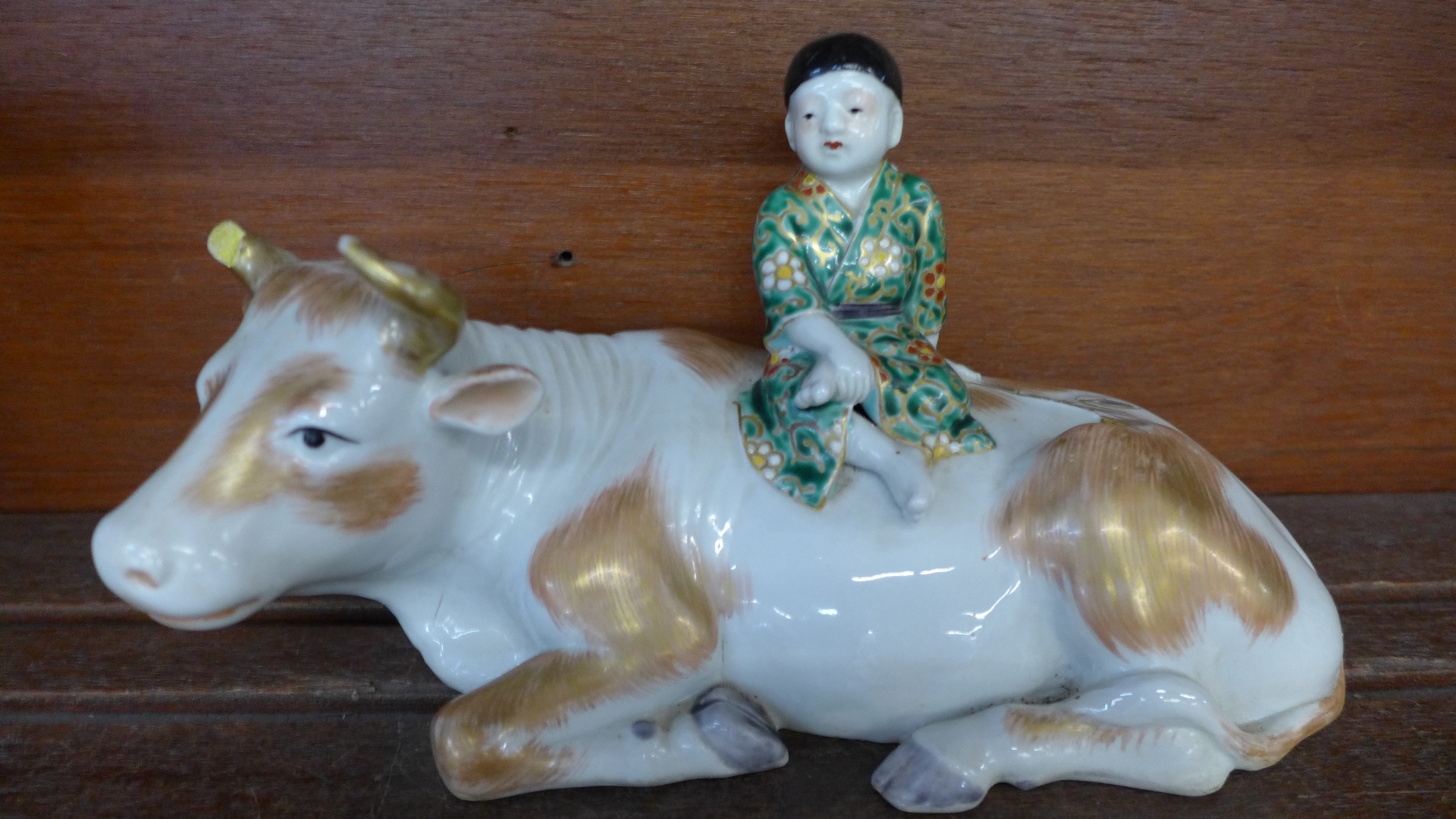 A Meiji period Arita porcelain boy and buffalo, buffalo a/f (horn missing)