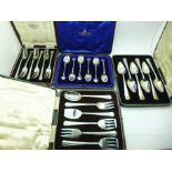 A set of six silver spoons and three other sets of flatware, all cased