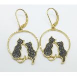 A pair of silver gilt black car earrings each with a black diamond accent