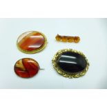 Four brooches including amber and agate set