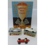 Three Crescent Toys model racing cars, two boxed and one unboxed, and a Grand Prix Cars shop