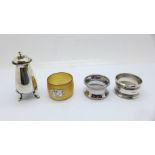Two silver napkin rings and a silver pepperette, 84g, and one other napkin ring