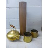 A brass kettle, a shell case and two others in brass