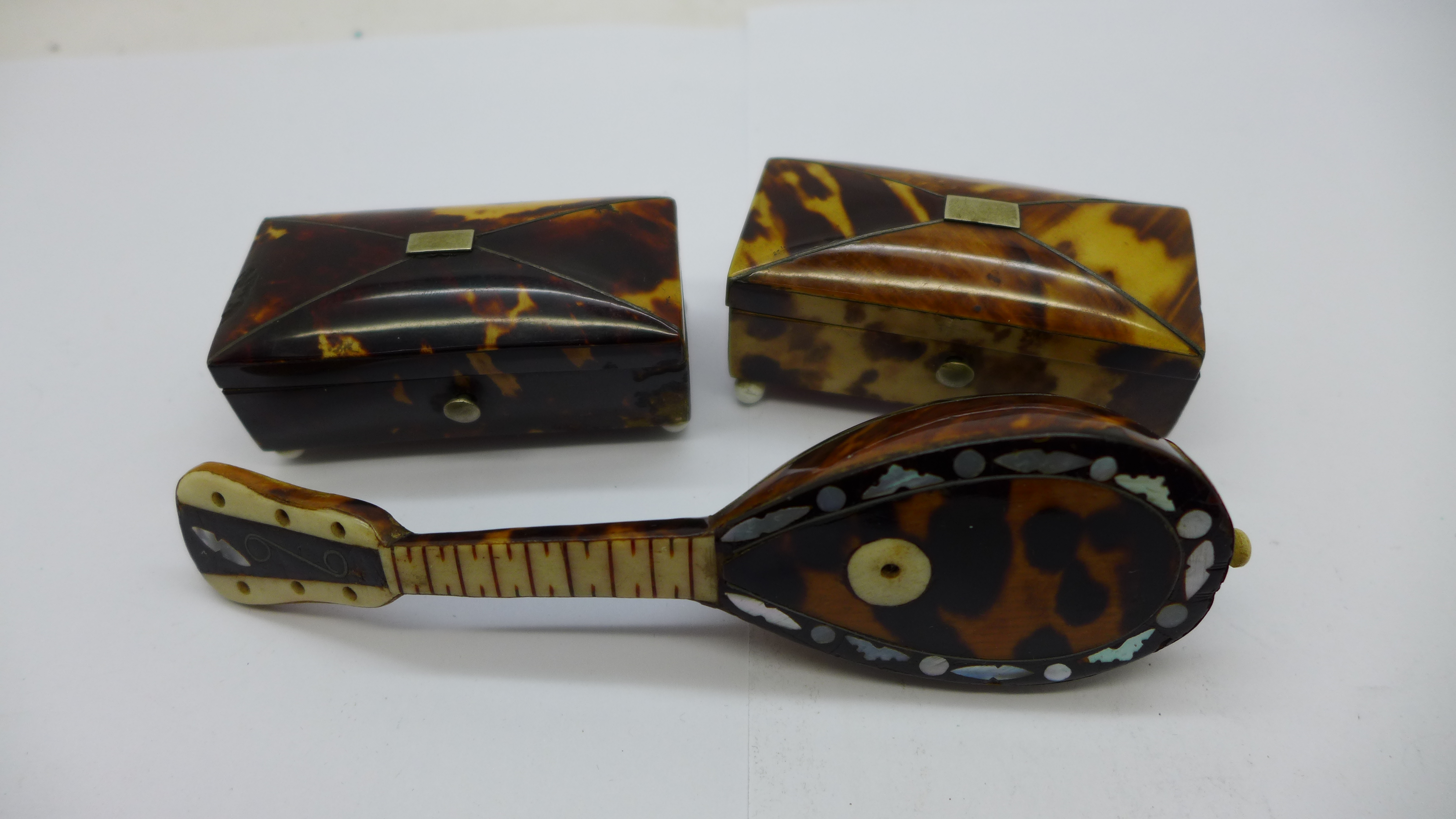 Two small caddy shaped tortoiseshell mounted boxes and a novelty miniature mandolin mounted with