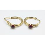 A pair of 18ct gold earrings set with red stones, 1.6g