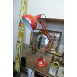 A red anglepoise lamp