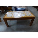 A teak and tile topped coffee table