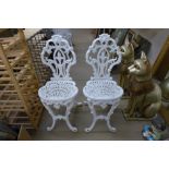 Two cast iron chairs