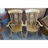 A pair of Victorian style beech farmhouse armchairs