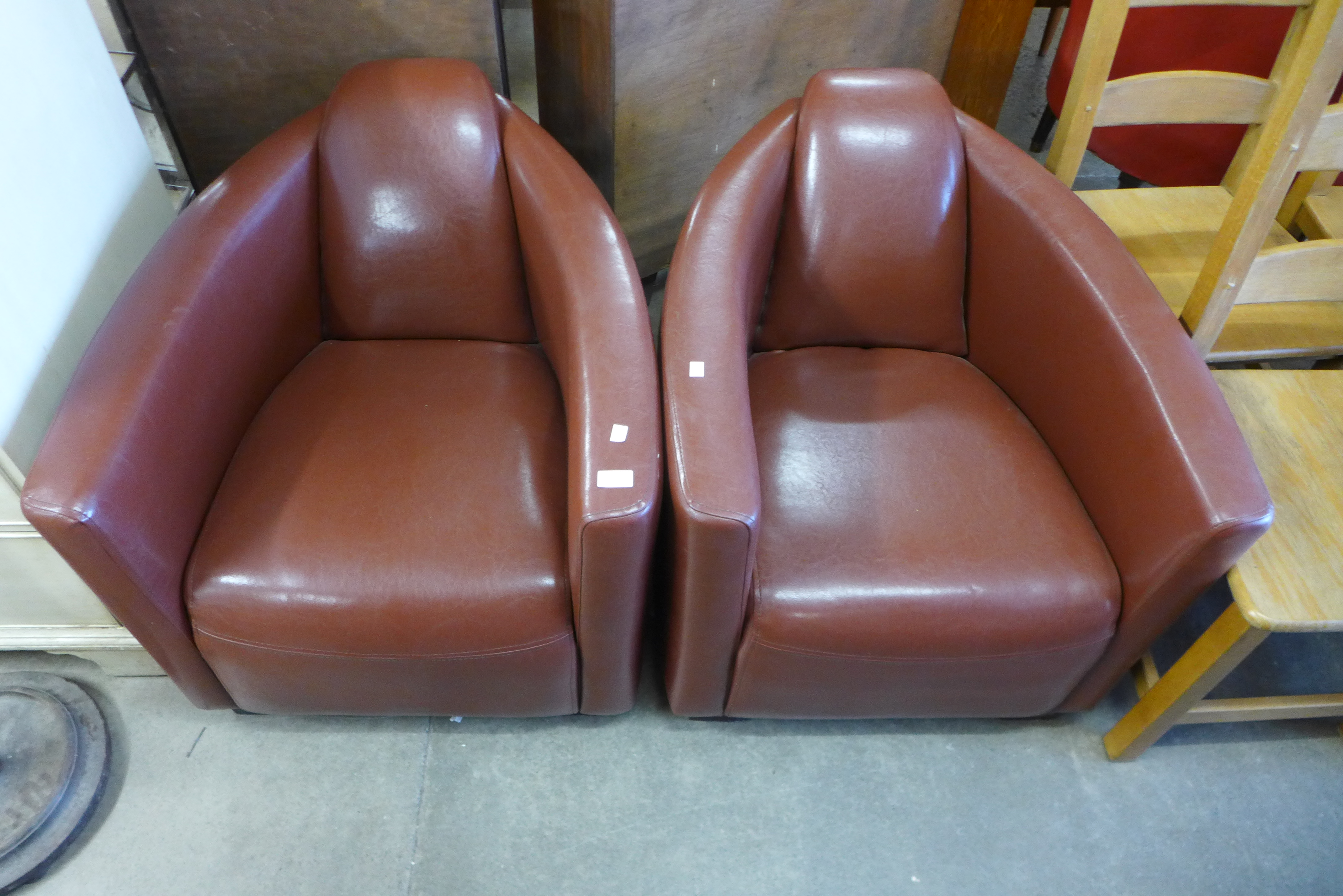 A pair of Art Deco style brown leather armchairs