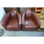 A pair of Art Deco style brown leather armchairs