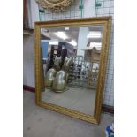 A gilt framed rectangular wall mirror