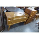 A light oak dressing table and a chest of drawers