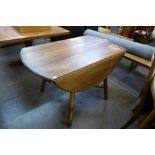 An Ercol drop-leaf dining table