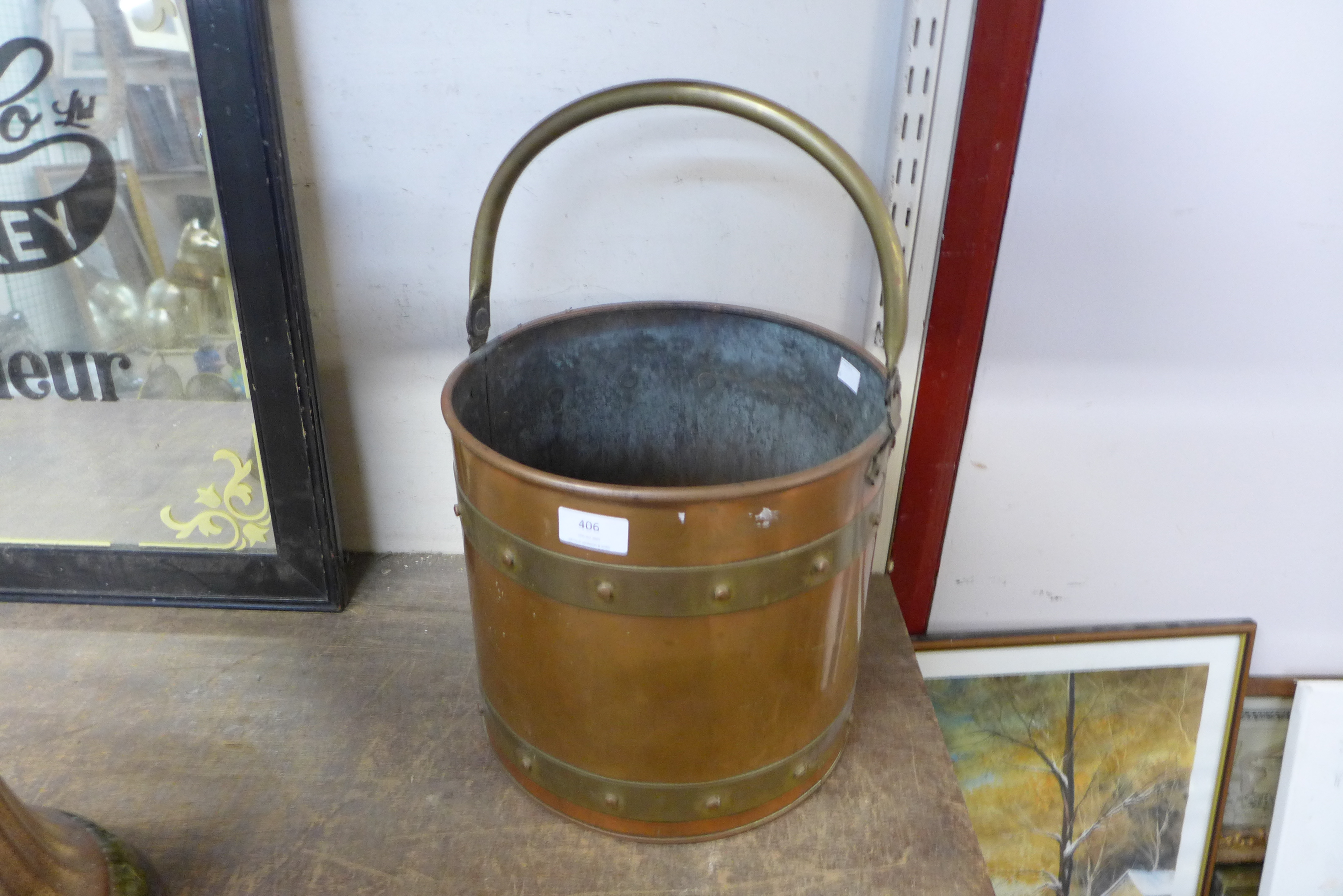 An Arts and Crafts brass and copper coal bucket