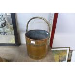 An Arts and Crafts brass and copper coal bucket