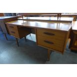 An Austin Suite teak desk (missing middle drawer)
