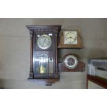 A wall clock and two mantel clocks