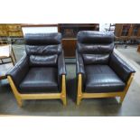 A pair of beech and leather upholstered armchairs