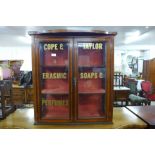 An Edward VII inlaid mahogany two door cabinet, doors bearing Cope & Taylor, Erasmic Soaps &