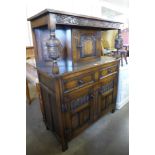 A carved oak court cupboard