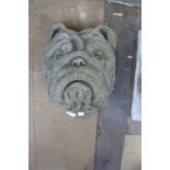 A concrete bust of a bulldog