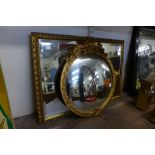 A circular gilt framed convex mirror and another
