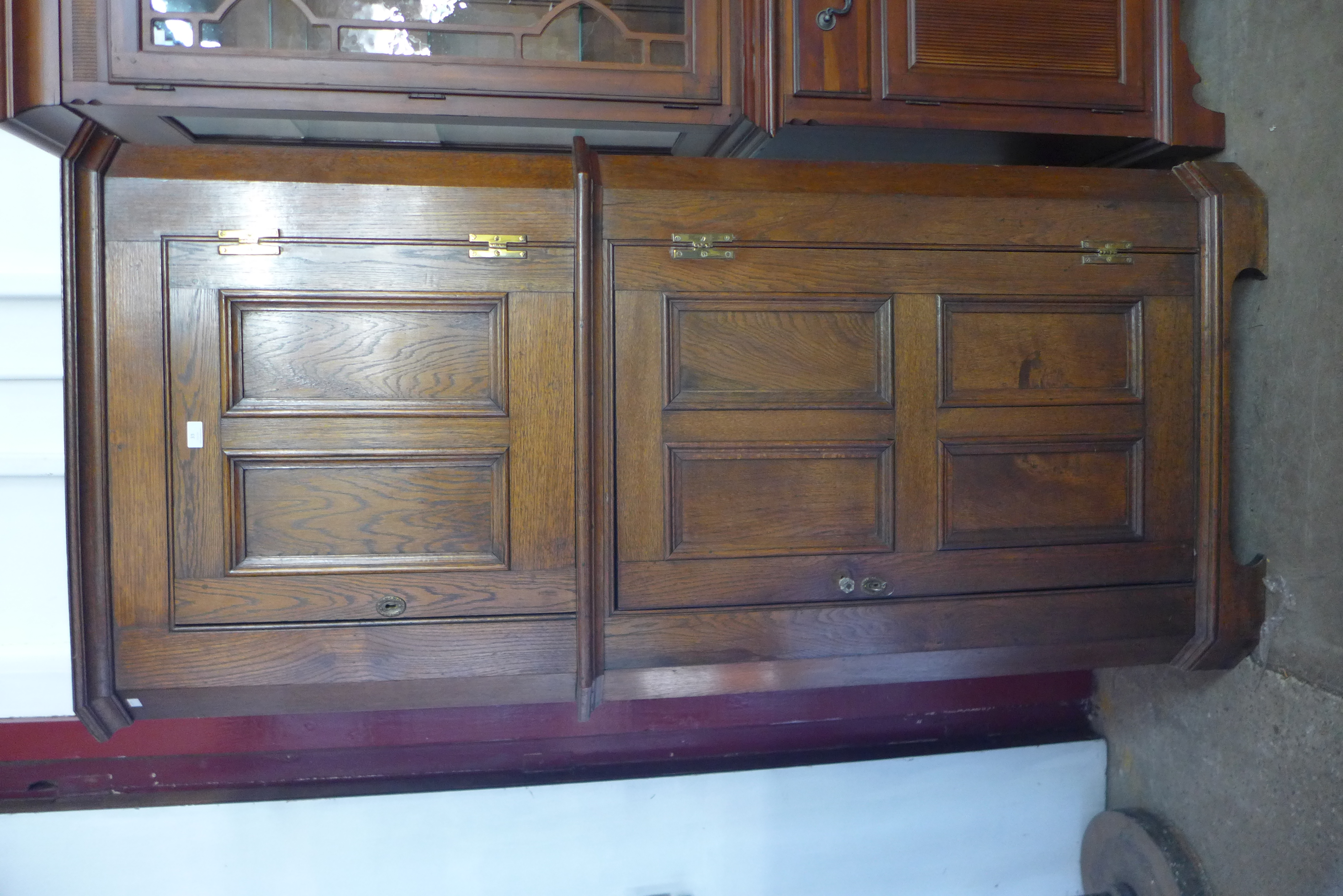 An oak two door corner cupboard