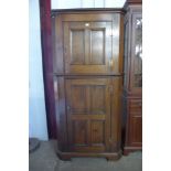 An oak two door corner cupboard