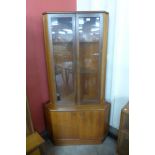 A Turnidge teak free standing corner cabinet