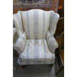 A mahogany and upholstered wingback armchair