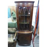 A mahogany freestanding corner cabinet